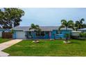 Inviting single-Gathering home featuring a beautifully landscaped front yard and boat on trailer at 13978 Barbados Dr, Seminole, FL 33776