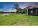 Expansive backyard with lush green grass and scenic water views; perfect for outdoor enjoyment at 14063 Wineberry Dr, Dade City, FL 33525