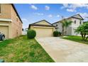 Well-manicured lawn and a two-car garage enhance this home's curb appeal at 14206 Covert Green Pl, Riverview, FL 33579
