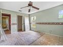 Bedroom awaiting renovation with ceiling fan and natural light at 14808 Lake Magdalene Cir, Tampa, FL 33613