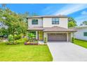 Beautiful two-story home with manicured lawn and a two-car garage at 14808 Lake Magdalene Cir, Tampa, FL 33613