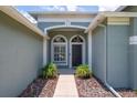 Inviting front entrance features a walkway leading to the front door, surrounded by lush landscaping at 15309 Palomapark Ln, Lithia, FL 33547