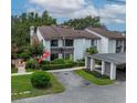 Exterior shot of a condo with lush landscaping and a covered carport at 1712 Lake Cypress Dr # 1604, Safety Harbor, FL 34695