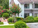 Charming two-story home with landscaped yard, blooming flowers, and manicured bushes at 1712 Lake Cypress Dr # 1604, Safety Harbor, FL 34695