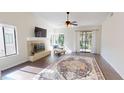Spacious living room with fireplace, hardwood floors, and lots of natural light from several windows at 1712 Lake Cypress Dr # 1604, Safety Harbor, FL 34695