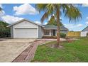 Charming single-Gathering home featuring a well-maintained yard and two-car garage at 1717 Osprey Ln, Lutz, FL 33549