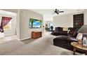 Comfortable living room features neutral carpet, a ceiling fan, and a media center at 1737 Bonita Bluff Ct, Ruskin, FL 33570