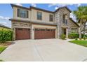 Inviting two-story home showcasing a stone facade, covered entry, and a spacious driveway at 21797 Briske Morning Ave, Land O Lakes, FL 34637