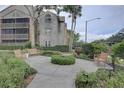 Charming courtyard with benches, greenery, and a central landscaped island for relaxation at 2500 Winding Creek Blvd # G307, Clearwater, FL 33761