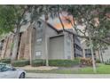 Condo with brick and siding exterior, complemented by manicured landscaping, trees, and adjacent parking at 2500 Winding Creek Blvd # G307, Clearwater, FL 33761