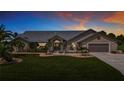 Beautiful single-story home with landscaped front yard and attached two-car garage at 27466 Tierra Del Fuego Cir, Punta Gorda, FL 33983