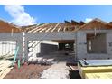 View of home construction showing concrete block walls and lumber for roof in residential neighborhood under blue sky at 2797 Marrakesh Ln, Sarasota, FL 34234