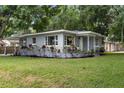 Attractive single-story home featuring a welcoming front porch and lush landscaping at 2902 W Lemon St, Tampa, FL 33609