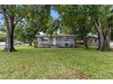 Quaint single-story home with well-maintained lawn and mature trees at 2902 W Lemon St, Tampa, FL 33609