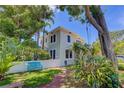 Charming home featuring a lush green front yard, brick pathway and a comfortable blue bench for relaxation at 4742 13Th N Ave, St Petersburg, FL 33713