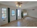 The cozy living room features wood floors, natural light, and neutral walls at 4851 W Gandy Blvd # B12L23, Tampa, FL 33611