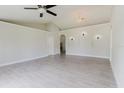 Open-concept living room with recessed lighting, arched wall decor, and wood-look tile floors at 4959 Cromey Rd, North Port, FL 34288
