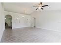 Spacious living room with arched doorways, recessed lighting, ceiling fan, and tile flooring at 4959 Cromey Rd, North Port, FL 34288