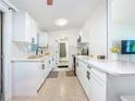 Modern kitchen with white cabinets, subway tile backsplash, black hardware, and a breakfast bar at 5600 Hobson Ne St, St Petersburg, FL 33703