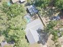 Aerial view of a home with a private pool and fenced yard surrounded by mature trees at 5614 Kenny Dr, Tampa, FL 33617