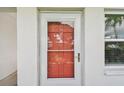 Condo entrance with red door, sidelight, and view of the exterior at 5728 14Th N Ave # 101B, St Petersburg, FL 33710