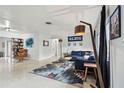 Spacious living room boasts a modern rug, contemporary furniture, and large windows for ample natural light at 5961 36Th Ave N, St Petersburg, FL 33710