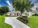 Charming single-story home featuring a lush landscaped yard, mature trees, and a well-maintained lawn on a sunny day at 6204 Rockross Ave, New Port Richey, FL 34655