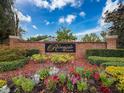 Beautiful brick Riverside Estates neighborhood entrance sign surrounded by colorful landscaping against a vibrant blue sky backdrop at 6204 Rockross Ave, New Port Richey, FL 34655