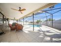 Inviting screened patio with comfortable seating overlooking the pool, perfect for outdoor relaxation and entertainment at 6503 Santiago Ct, Apollo Beach, FL 33572