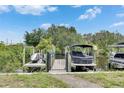 Dock featuring boats, jet skis, and gated entry with a waterfront view at 6512 Simone Shores Cir, Apollo Beach, FL 33572