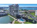 Beautiful view of condo building with pool, waterway, and covered parking at 7300 Sun Island S Dr # 1505, South Pasadena, FL 33707