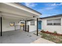 Close-up shot of the home's carport and vibrant blue front door at 7524 Tidewater Trl, Tampa, FL 33619