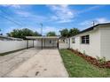 Side view of a white home featuring a carport and fresh landscaping at 7524 Tidewater Trl, Tampa, FL 33619