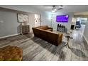 Comfortable living room with hardwood floors, a plush brown sofa, and a ceiling fan at 8341 41St N Ave, St Petersburg, FL 33709