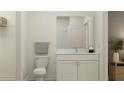 Cozy bathroom featuring a modern vanity with granite countertops and minimalist decor at 9583 Runaway Breeze Dr, Land O Lakes, FL 34637