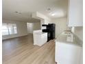Modern kitchen with white cabinets, granite countertops, stainless steel appliances, and an open layout at 1003 Cornwall Ct, Brandon, FL 33510