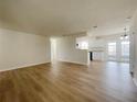 Spacious room featuring modern wood floors, and open access to the kitchen and outdoor spaces at 1003 Cornwall Ct, Brandon, FL 33510