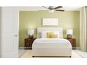 Comfortable bedroom with neutral tones, a ceiling fan, and matching bedside lamps at 10113 Trumpet Honetsuckle Way, San Antonio, FL 33576