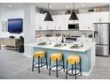 Modern kitchen with white cabinets, a large center island, and stainless steel appliances at 11313 Hardwood Hammock Ln, Riverview, FL 33569