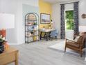 Bright home office with large window, stylish decor, and modern desk setup at 11313 Hardwood Hammock Ln, Riverview, FL 33569