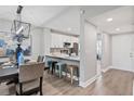 Open dining area with modern light fixture, breakfast bar and view of kitchen at 11510 Shipwatch Dr # 1372, Largo, FL 33774