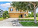 Two-story home featuring a two-car garage, inviting entrance, and well-maintained landscaping at 12244 Fairlawn Dr, Riverview, FL 33579
