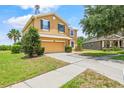 Attractive two-story home with manicured lawn, and a long driveway leading to a two-car garage at 12244 Fairlawn Dr, Riverview, FL 33579