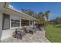 Inviting front porch with comfortable outdoor seating and manicured landscaping creating a relaxing ambiance at 1368 Whispering Pines Dr, Clearwater, FL 33764