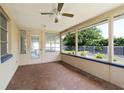 Screened in porch featuring tile flooring, neutral paint, and a ceiling fan for comfortable outdoor living at 13898 Jamaica Dr, Seminole, FL 33776