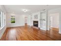 Bright living room featuring hardwood floors, fireplace, and built-in bookshelves at 13917 8Th St, Dade City, FL 33525