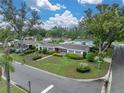 Lovely residential home with landscaped front yard, mature trees, and a well-maintained lawn on a sunny corner lot at 140 Morrow Cir, Brandon, FL 33510