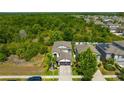 Aerial view of a lovely home nestled amidst lush greenery, offering privacy and tranquility at 14716 Crescent Rock Dr, Wimauma, FL 33598