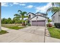 Beautifully landscaped two-story home with a two-car garage and inviting curb appeal at 14716 Crescent Rock Dr, Wimauma, FL 33598