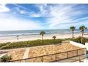 Large tiled balcony providing ocean views with palm trees dotting the landscape at 15000 Gulf Blvd # 407, Madeira Beach, FL 33708